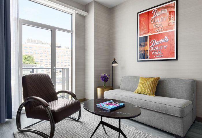 Gansevoort Meatpacking NYC hotel room. Gay-friendly hotel with chair, sofa, and art. Meatpacking District hotel interior.