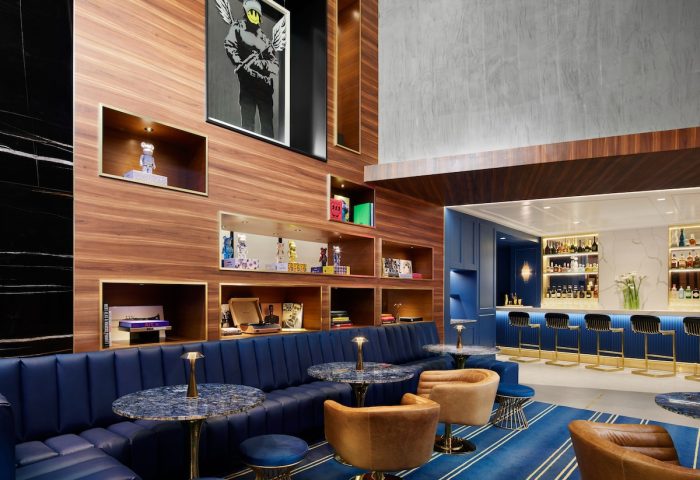 Gansevoort Meatpacking NYC gay-friendly hotel bar. Stylish lounge area with blue seating, bar, & art. A top choice for gay travelers.