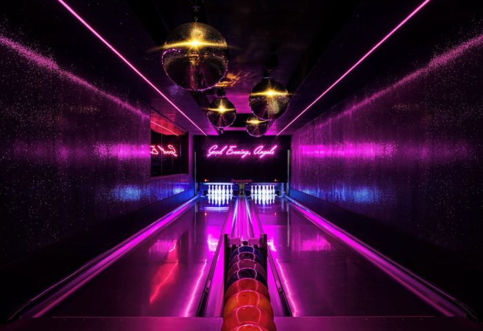 Gansevoort Meatpacking NYC gay-friendly hotel bowling alley. Disco balls, neon lights, and bowling lanes create a fun, inclusive atmosphere.