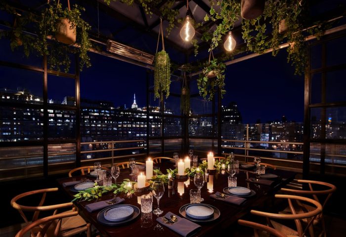 Gansevoort Meatpacking NYC gay-friendly hotel rooftop dining. Candles, greenery, and city views for a memorable experience.