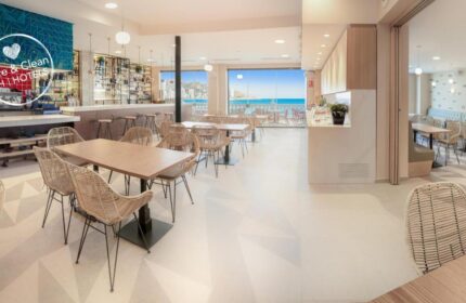Gastrohotel Boutique RH Canfali restaurant. Tables and chairs face the sea. Gay-friendly hotel with bar and dining. Safe & Clean Hotel.