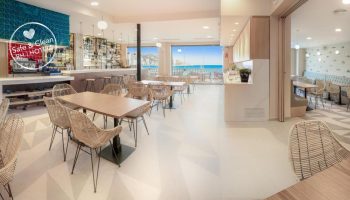 Gastrohotel Boutique RH Canfali restaurant. Tables and chairs face the sea. Gay-friendly hotel with bar and dining. Safe & Clean Hotel.