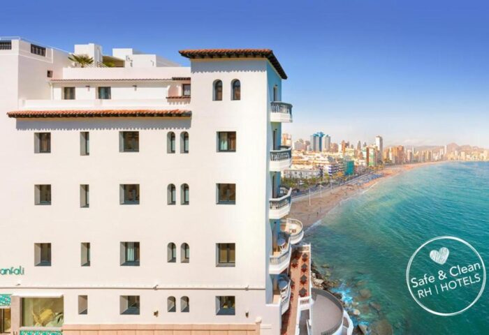 Gastrohotel Boutique RH Canfali, a gay-friendly hotel. Exterior view of the hotel overlooking the beach and city. Coastal gay travel.