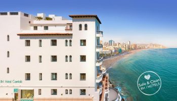 Gastrohotel Boutique RH Canfali, a gay-friendly hotel. Exterior view of the hotel overlooking the beach and city. Coastal gay travel.