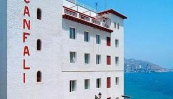 Gastrohotel Boutique RH Canfali, a gay-friendly hotel. Exterior view of the white building with red lettering, near the sea.