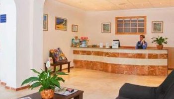 Gastrohotel Boutique RH Canfali's lobby. Reception area with staff, seating, and tourist information. Gay-friendly hotel interior.