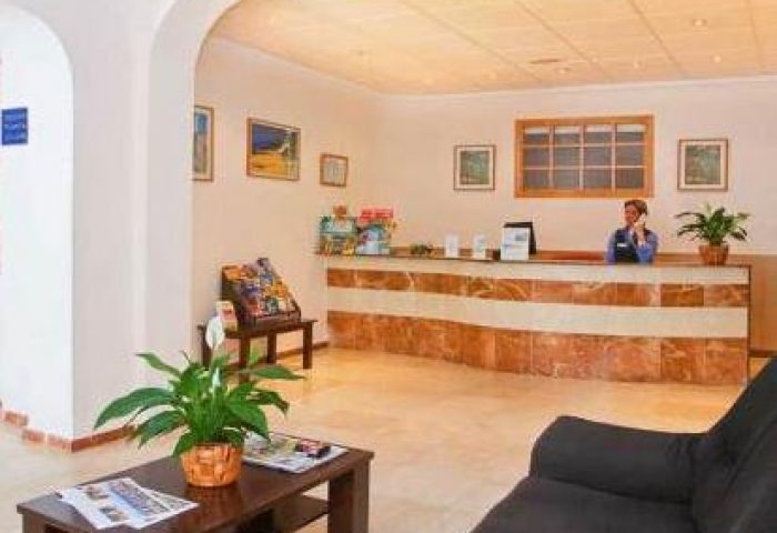 Gastrohotel Boutique RH Canfali's lobby. Reception area with staff, seating, and tourist information. Gay-friendly hotel interior.