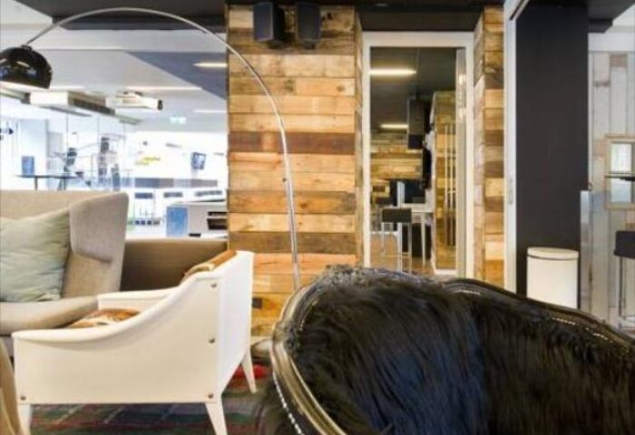 Generator Copenhagen hotel interior. A gay-friendly hotel with modern design, wooden walls, stylish furniture, and a cool, welcoming vibe.