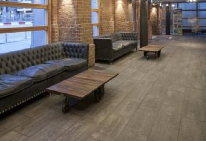 Generator Hostel Dublin interior. Lounge area with leather sofas and wooden tables. Gay-friendly hotel with modern design.