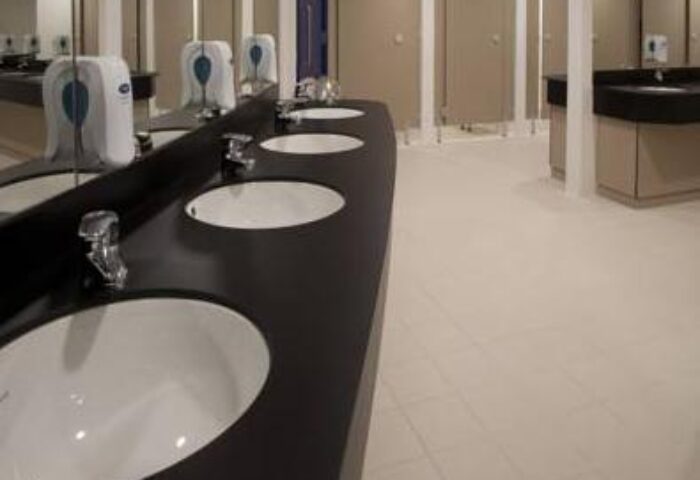 Generator Hostel Dublin bathroom interior. Reviews of this gay-friendly hotel show clean communal sinks and toilet stalls.