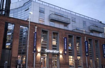 Generator Hostel Dublin exterior. Gay-friendly hotel with modern architecture, brick facade, and Generator banners. Reviews suggest a great stay.