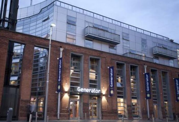 Generator Hostel Dublin exterior. Gay-friendly hotel with modern architecture, brick facade, and Generator banners. Reviews suggest a great stay.