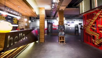 Generator London's lobby. This gay-friendly, pet-friendly hotel features a stylish reception area with a hello sign and modern design.