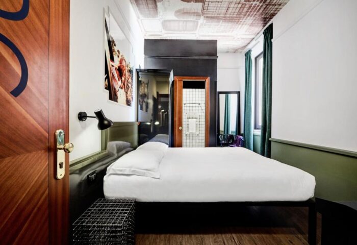 Generator Rome gay-friendly hotel: a stylish room with a double bed, modern decor, and a bathroom view. Perfect for gay travelers in Rome.