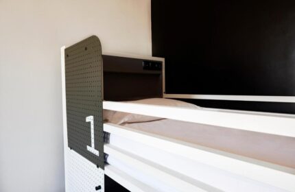 Generator Rome gay-friendly hotel: Modern bunk bed with number one. Stylish, clean accommodation for gay travelers in Rome.