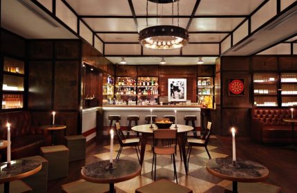 Gild Hall, A Thompson Hotel bar area. Gay-friendly hotel with stylish bar, seating, and warm lighting. Great for gay travel.