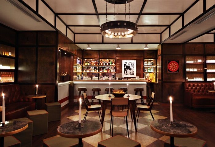 Gild Hall, A Thompson Hotel bar area. Gay-friendly hotel with stylish bar, seating, and warm lighting. Great for gay travel.