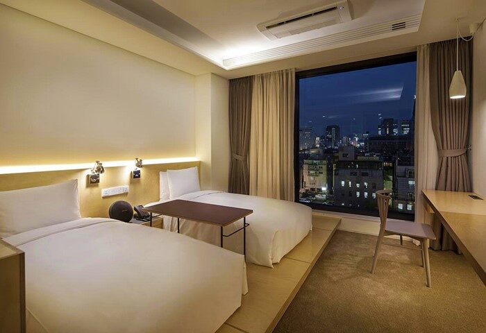 Glad Live Gangnam Hotel room with two beds and city view. Gay-friendly hotel in Seoul, South Korea. Modern design, comfortable for LGBTQ travelers.