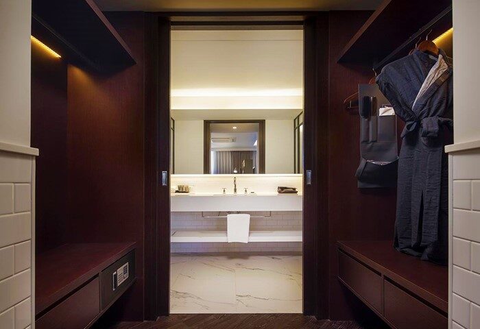 Glad Live Gangnam hotel closet, a gay-friendly hotel. View into the bathroom, with robe. For gay men travel advice.