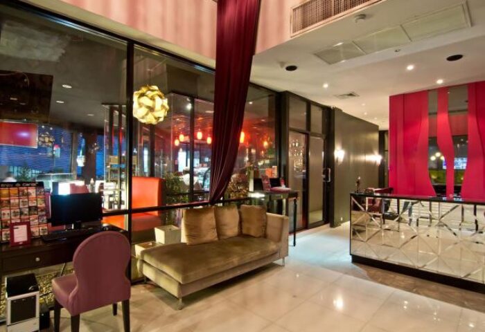 Glitz Hotel lobby interior. Gay-friendly hotel with modern design, lounge area, and reception desk. Ideal for gay men travel.