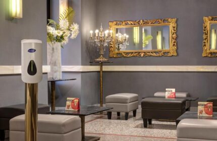 Golden Tulip Rome Piram gay-friendly hotel lounge area. Mirrors, chandelier, and seating create an elegant, welcoming space.