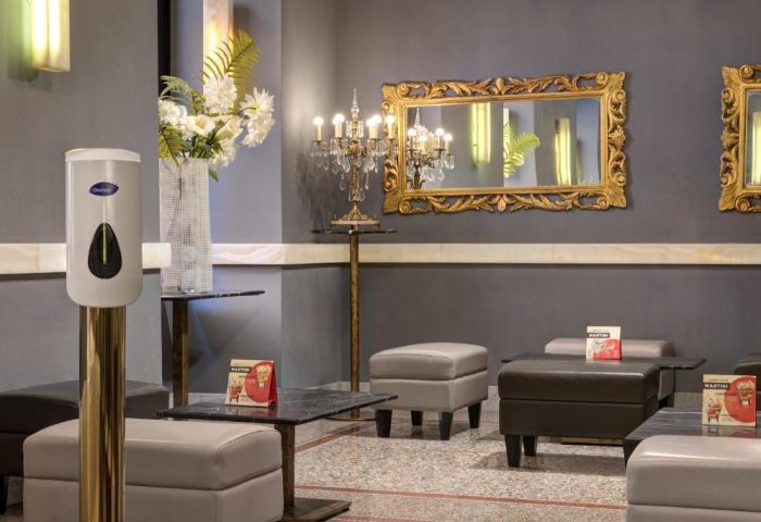 Golden Tulip Rome Piram gay-friendly hotel lounge area. Mirrors, chandelier, and seating create an elegant, welcoming space.