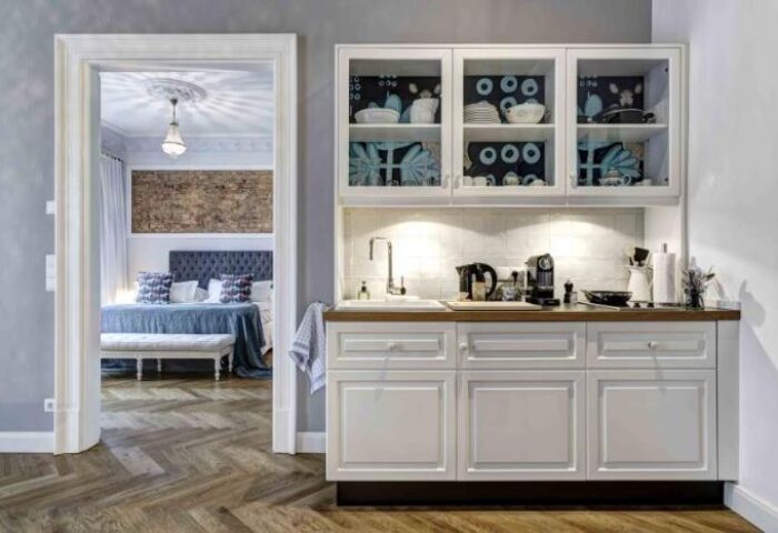 Gorki Apartments' pet-friendly kitchen. A cozy view into the bedroom. Gay-friendly hotel with modern design and amenities.