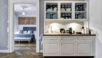 Gorki Apartments' pet-friendly kitchen. A cozy view into the bedroom. Gay-friendly hotel with modern design and amenities.