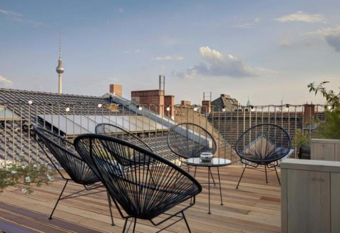 Gorki Apartments pet-friendly rooftop terrace view. Gay-friendly hotel in Berlin with outdoor seating and the TV tower in the background.