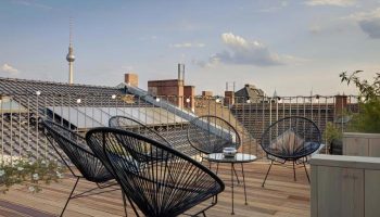 Gorki Apartments pet-friendly rooftop terrace view. Gay-friendly hotel in Berlin with outdoor seating and the TV tower in the background.