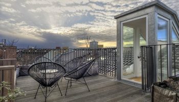 Gorki Apartments' pet-friendly terrace view. This gay-friendly hotel offers stylish outdoor spaces for relaxation and enjoying the city skyline.