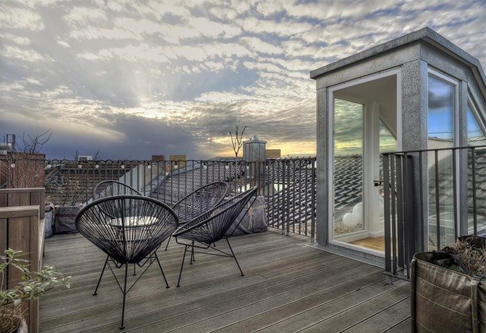 Gorki Apartments' pet-friendly terrace view. This gay-friendly hotel offers stylish outdoor spaces for relaxation and enjoying the city skyline.