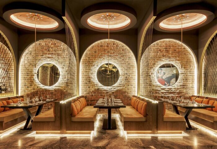 Grand Fiesta Americana Coral Beach Cancun restaurant. Chic interior with brick arches, booths, and circular mirrors. Gay-friendly hotel.