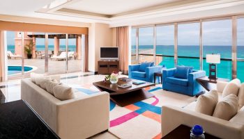 Grand Fiesta Americana Coral Beach Cancun All Inclusive suite. Ocean view, living area, and pool. Gay-friendly hotel room.