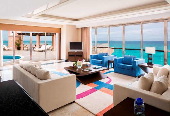 Grand Fiesta Americana Coral Beach Cancun All Inclusive suite. Ocean view, living area, and pool. Gay-friendly hotel room.