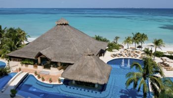 Grand Fiesta Americana Coral Beach Cancun all-inclusive gay-friendly hotel aerial view. Pool bar, beach, and turquoise ocean.