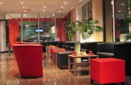 Grand Hotel Dream Main City Center lounge area. Gay-friendly hotel with modern design, red accents, and comfortable seating. Ideal for gay travel.