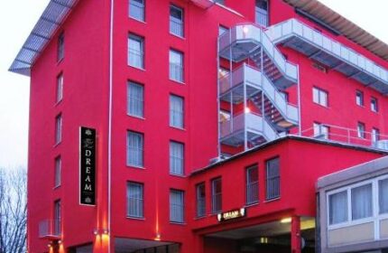 Grand Hotel Dream Main City Center, a gay-friendly hotel. Red building with stairs, catering to gay travelers in a central location.