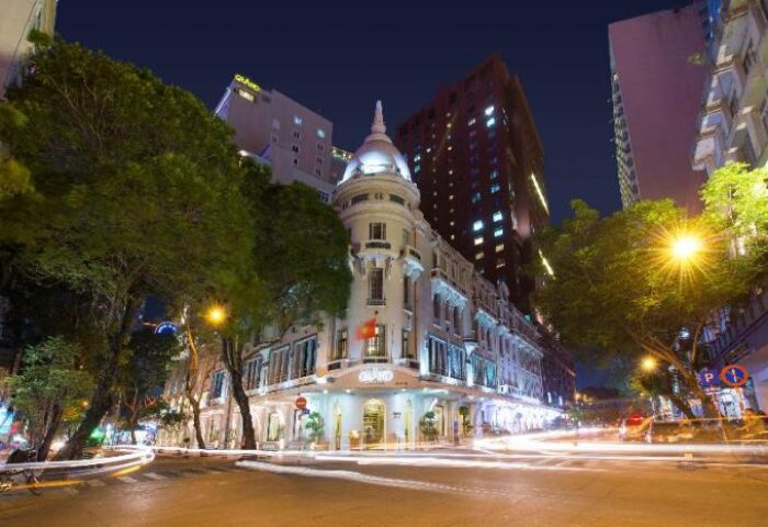 Grand Hotel Saigon at night. Gay-friendly hotel in Vietnam with illuminated facade and street view. A top choice for gay travelers.