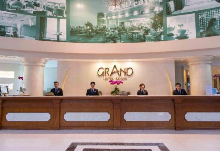 Grand Hotel Saigon's reception desk with staff. A gay-friendly hotel offering luxury accommodations and service in Ho Chi Minh City.