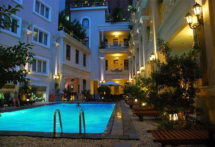 Gay-Friendly Grand Hotel Saigon pool view. Outdoor pool at night. Saigon's gay travel scene. Relaxing at the hotel's pool.