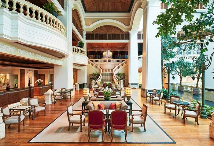 Grand Hyatt Erawan Bangkok's grand lobby. This gay-friendly hotel features a stunning staircase, seating areas, and elegant design.