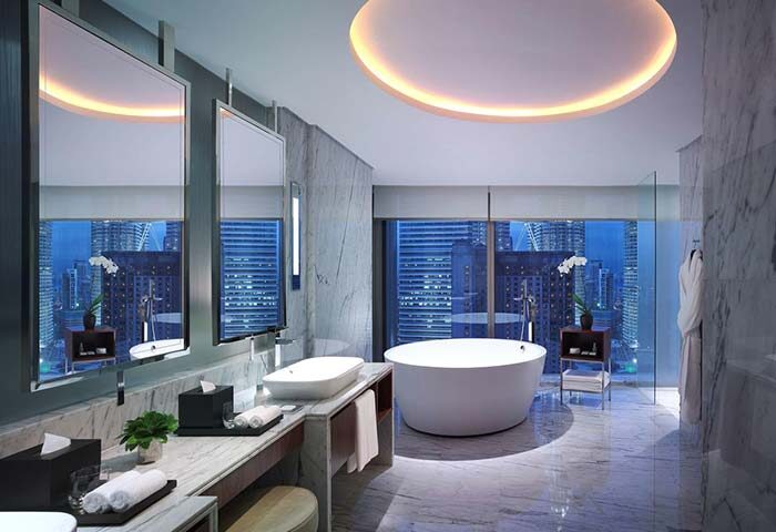 Grand Hyatt Kuala Lumpur Hotel bathroom. Modern design with a tub, marble, and city views. Gay-friendly hotel for LGBTQ+ travelers.
