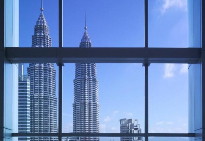 Petronas Towers view from Grand Hyatt Kuala Lumpur Hotel. Gay-friendly hotel in Kuala Lumpur, Malaysia. Window view of city skyline.