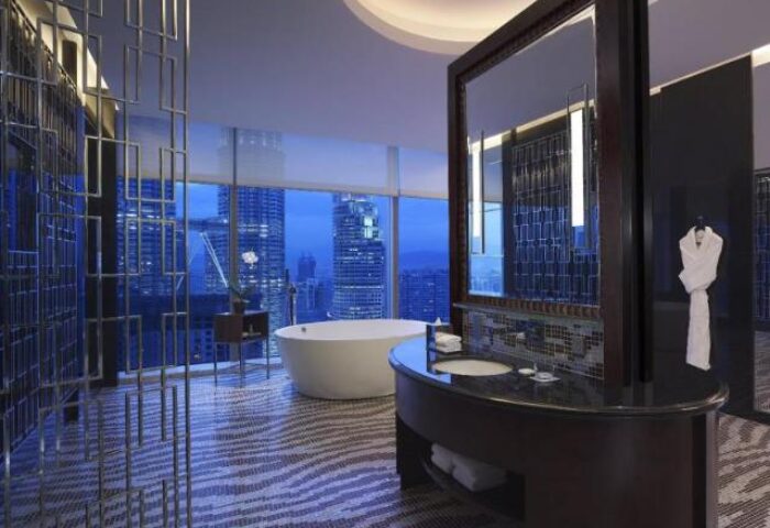 Grand Hyatt Kuala Lumpur Hotel bathroom. Modern design, tub with city view. Gay-friendly hotel for gay men travelers.