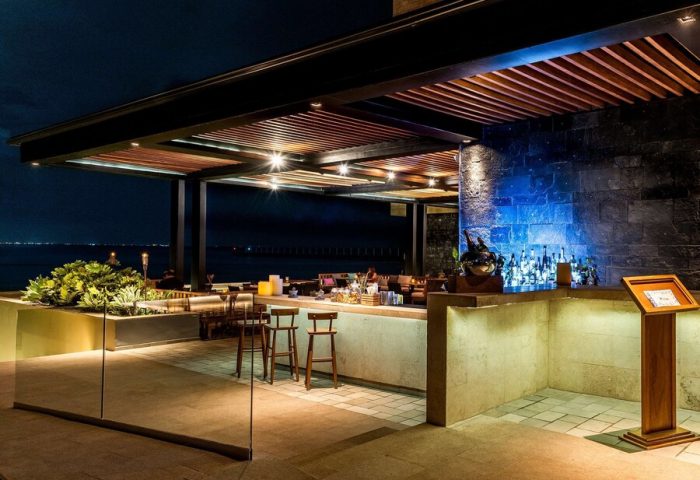 Grand Hyatt Playa Del Carmen Resort gay-friendly bar at night. Stylish outdoor bar with ocean view, perfect for gay travelers.
