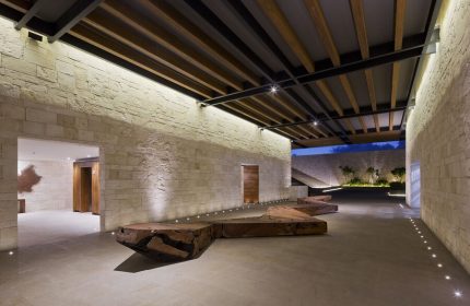 Grand Hyatt Playa Del Carmen Resort's lobby. This gay-friendly hotel boasts modern design, stone walls, wood accents, and inviting spaces.