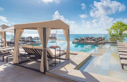 Grand Hyatt Playa Del Carmen Resort gay-friendly hotel pool view. Cabana, lounge chairs, and ocean views. Ideal for gay travel in Playa del Carmen.