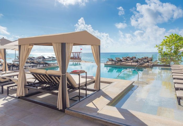 Grand Hyatt Playa Del Carmen Resort gay-friendly hotel pool view. Cabana, lounge chairs, and ocean views. Ideal for gay travel in Playa del Carmen.