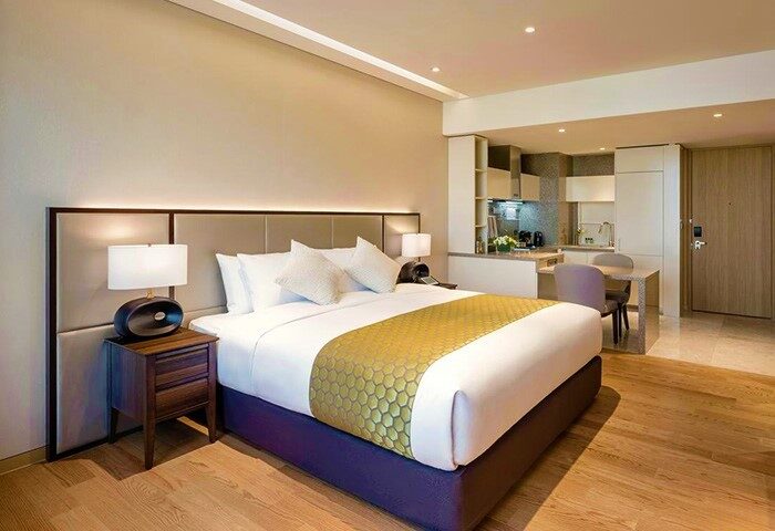 Grand Mercure Ambassador Hotel and Residences Seoul Yongsan room. Gay-friendly hotel room with bed, kitchenette, and modern decor. Seoul travel.